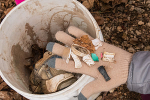 Women with her hand out showing small pieces of trash that were collected during a local clean up