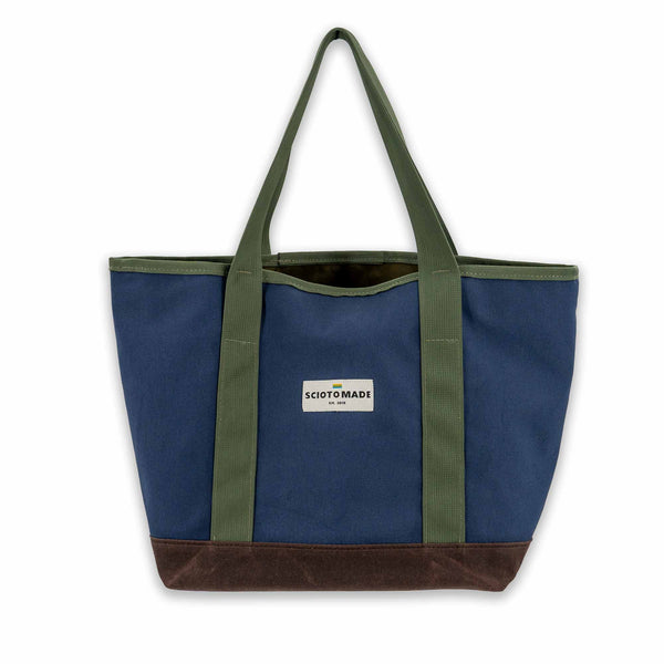 Darby Tote: Spacious, organized, and durable in navy duck cloth and brown waxed canvas. Made in the USA. Size: 13" L x 7" W x 12" H.