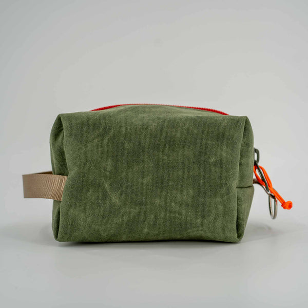 Travel Dopp Kit in green waxed canvas back view.