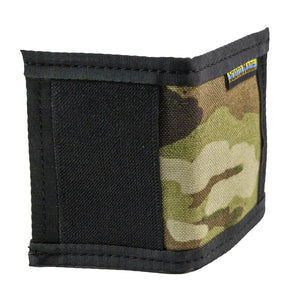 Camo bifold wallet with black trim. Made to hold 8 to 12 cards and has a 2" exterior elastic cash strap on the back. Side view showing black elastic cash strap. 