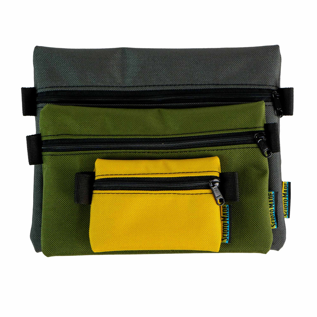 Image showing three accessory bags in yellow, olive, and smoke colors. Sizes include Mini (4.5" x 3.5"), Small (8.25" x 5.75"), and Medium (9" x 7.75"). Made from durable 1000D Cordura fabric with a 400D pack cloth interior. Perfect for organizing everyday carry items or travel essentials. Made in USA.