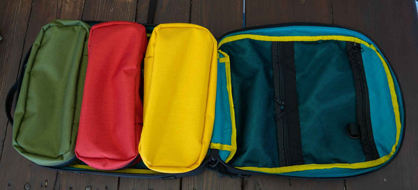 This 4L yellow packing cube is made with durable 1000D Cordura and lined with bright 400D pack cloth.  Inside there are two internal mesh pockets to make organization simple. Three packing cubes shown in yellow, red and green inside the 21L backpack.