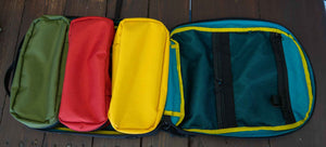 This 4L yellow packing cube is made with durable 1000D Cordura and lined with bright 400D pack cloth.  Inside there are two internal mesh pockets to make organization simple. Three packing cubes shown in yellow, red and green inside the 21L backpack.