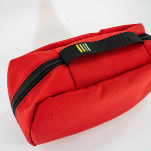 This 4L Red Packing Cube is made with 1000D Cordura and bright yellow 400D Pack Cloth inside. Two internal mesh pockets were added to make organization simple. Close up view of the exterior grab handle with the Scioto Made stripes embroidered on it.  