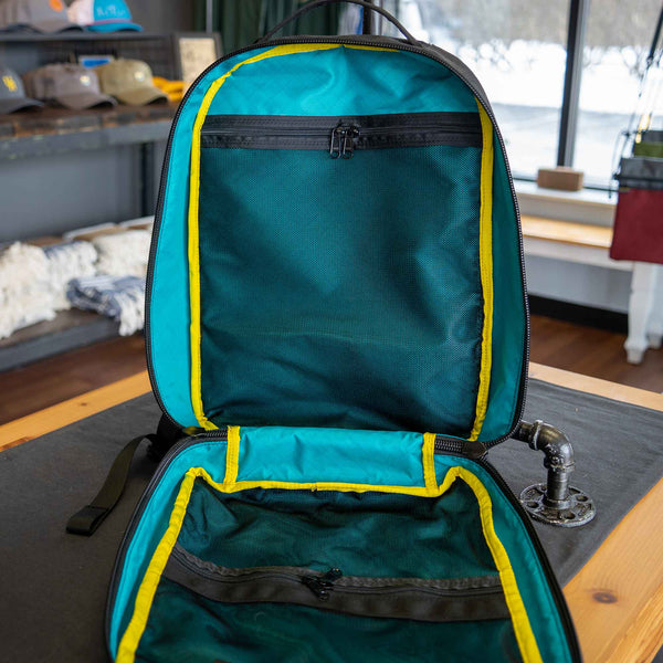 21L 1000D Cordura Backpack in all black. Showing inside view of mesh pockets. Inside color is teal.
