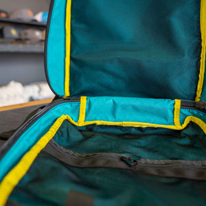 21L 1000D Cordura Backpack in all black. Showing inside view of mesh pockets. Inside color is teal.