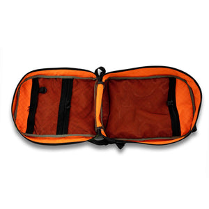 The 21L Backpack is large enough for a multi-day trip and simple enough for everyday use. Inside view in orange showing black mesh back pockets.  Clamshell deigns allow the bag to lay flat for easy packing.