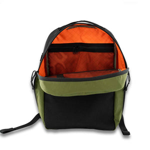 The 21L Backpack is large enough for a multi-day trip and simple enough for everyday use. Inside view in orange showing black mesh back pocket.