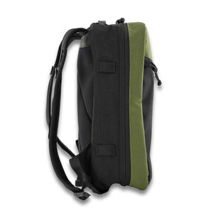 The 21L Backpack is large enough for a multi-day trip and simple enough for everyday use. Side View in Olive and Black.