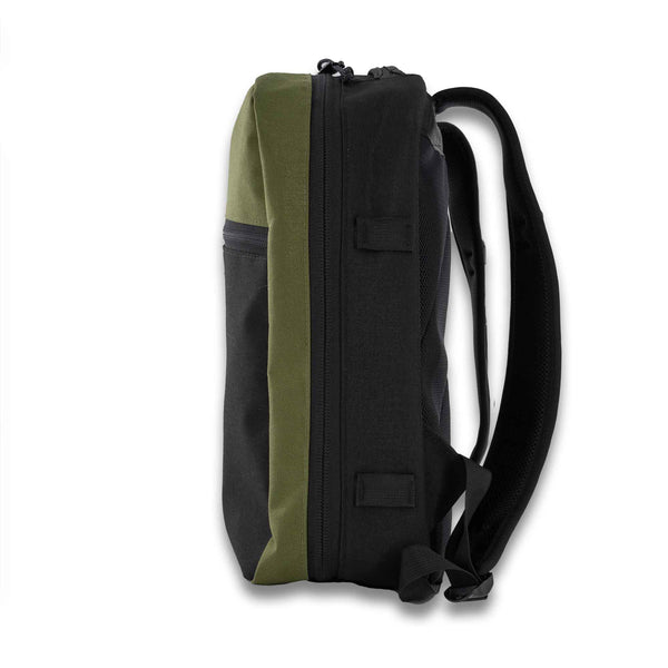 The 21L Backpack is large enough for a multi-day trip and simple enough for everyday use. Side View in Olive and Black.