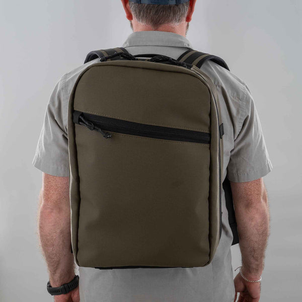 Man wearing 21L backpack in Ranger Green. 