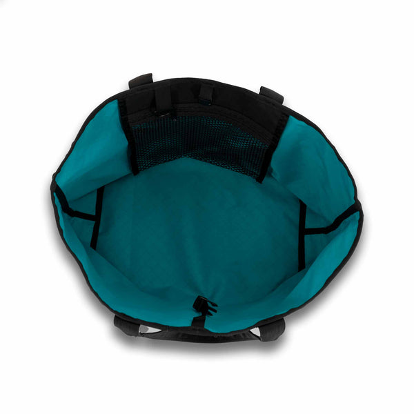 Scioto Made Boat Tote. Outside colors black main body and teal pocket. Interior color is teal. Showing interior mesh pocket.