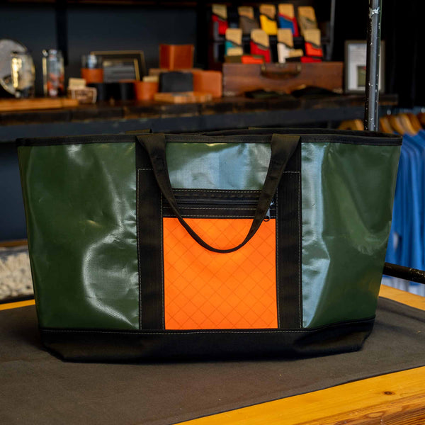 Scioto Made Boat Tote.  Outside colors olive, orange, black.  Front view shown in the shop.                    