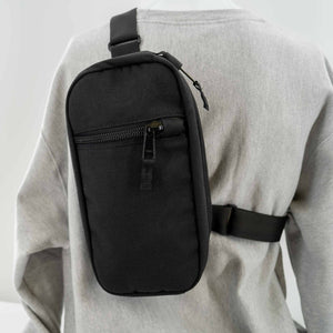 Hayden Sling Bag in Black. Front view showing front pocket.