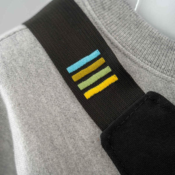 Black strap showing embroidered Scioto Made stripes.