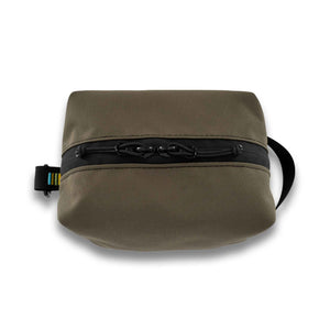 Handmade with premium materials this dopp kit is built to last throughout your travels and beyond. It will hold all your essential toiletry and accessory needs with ease.  Made with an aqua guard zipper to protect your items from the elements while exploring the great outdoors. Outside material is 1000D CORDURA in ranger green.  The inside is lined with yellow pack cloth. Made in Ohio.