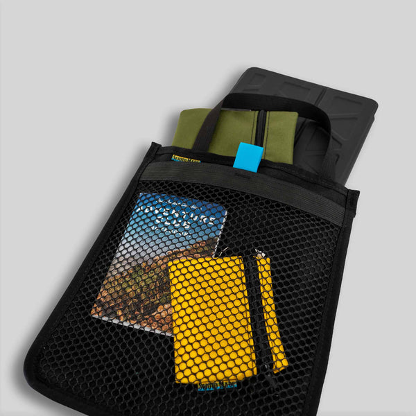 Scioto Made iPad Sleeve. Features outside mesh pocket and bright teal interior. All black exterior with teal pull tab for mesh pocket.  Carrying handle on top.  Size 10" x 12".  Shown with iPad, mini and small accessory bags and adventure book. 