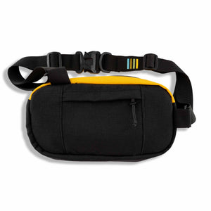 The Hayden sling bag is ready to go on any adventure!  This urban sling bag is made for everyday travel and hiking. Made with 1000D Cordura, it’s rugged enough to take on your hiking adventures and light enough for a trip to your favorite outdoor patio. Back view with exterior colors of black and yellow and features back hidden zipper pocket.